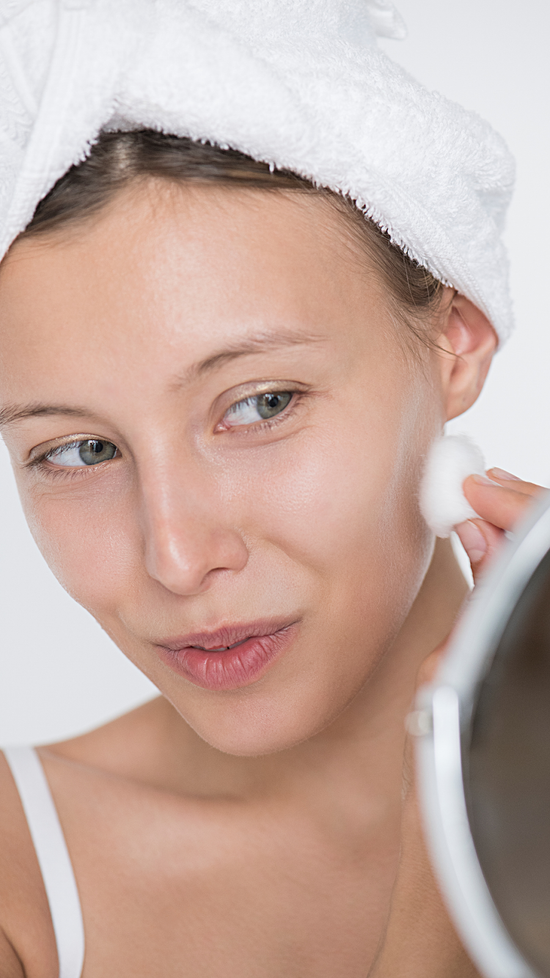 A Happy Woman Looking At The Results After Using Moisturizer For Acne Prone Skin