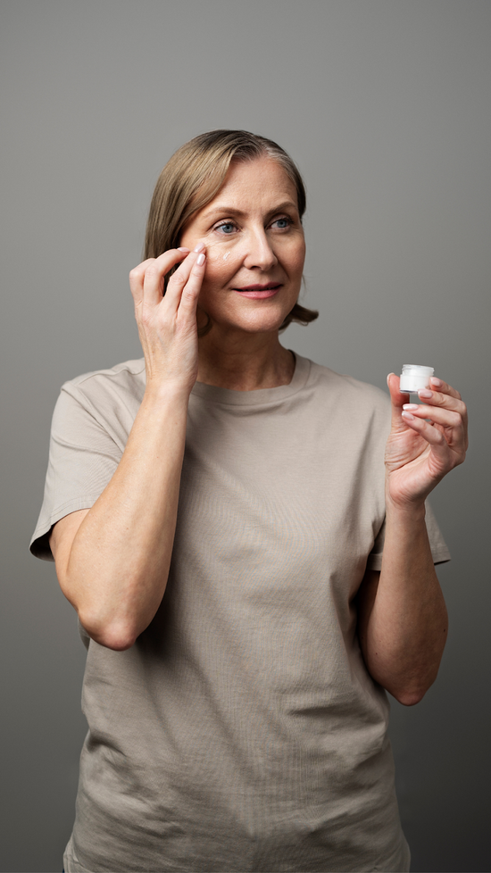 Portrait of an Older Woman Using Facial Moisturizer For Aging Skin