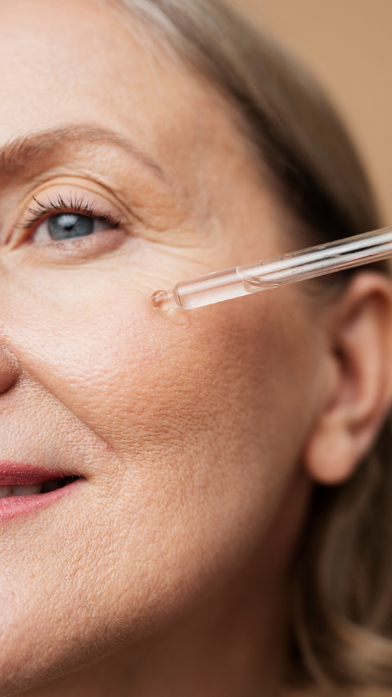 Woman Applying Sun Spots Serum on Mature Skin