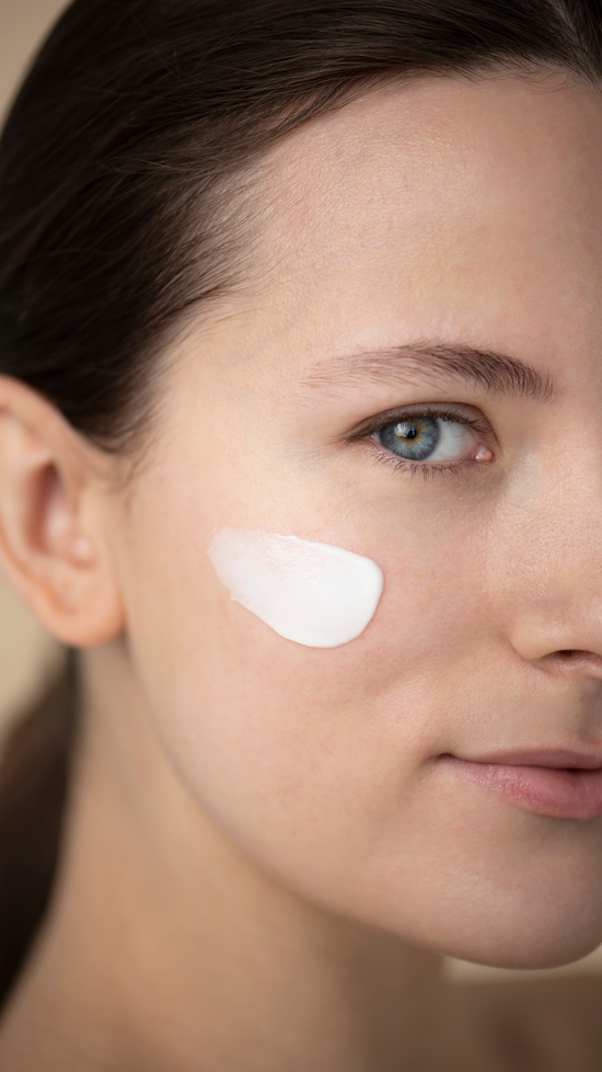Young Woman With A Splash of Moisturizer On Face